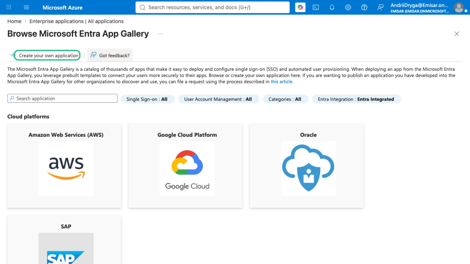 Entra's Browse Microsoft Entra App Gallery blade with the Create your own application button outlined in green, above gallery tiles for Amazon Web Services, Google Cloud Platform, Oracle and SAP.