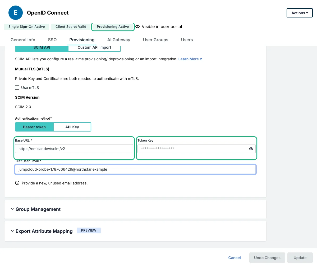 The Provisioning tab of a live JumpCloud OpenID Connect application with the Provisioning Active badge outlined in green. Authentication method is Bearer token, Base URL contains https://emisar.dev/scim/v2, Token Key is masked, and both credential fields are outlined in green.